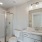 Lighted vanity/sink in bathroom with walk-in shower in homes at Lookout View Townhomes