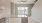 Modern kitchen facing living area with ceiling fan and light fixtures at Lookout View Townhomes