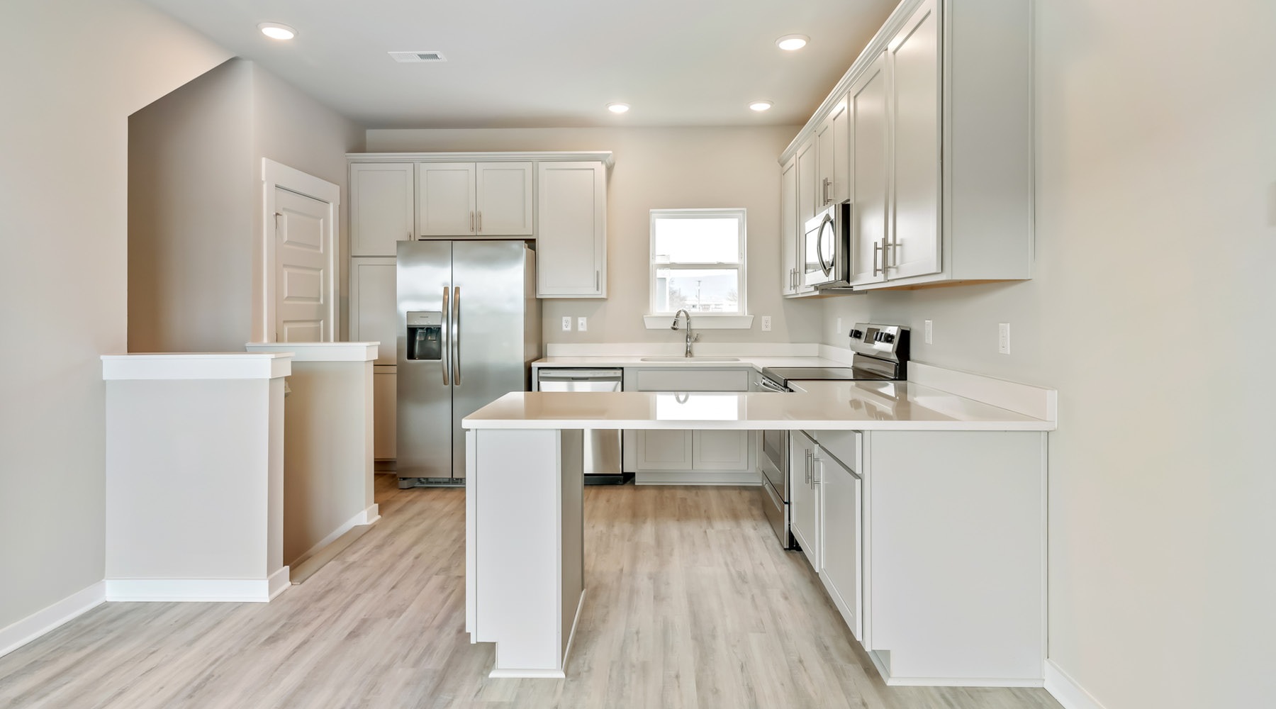 Life Is An Adventure Modern townhome kitchen open to living room at Lookout View Townhomes