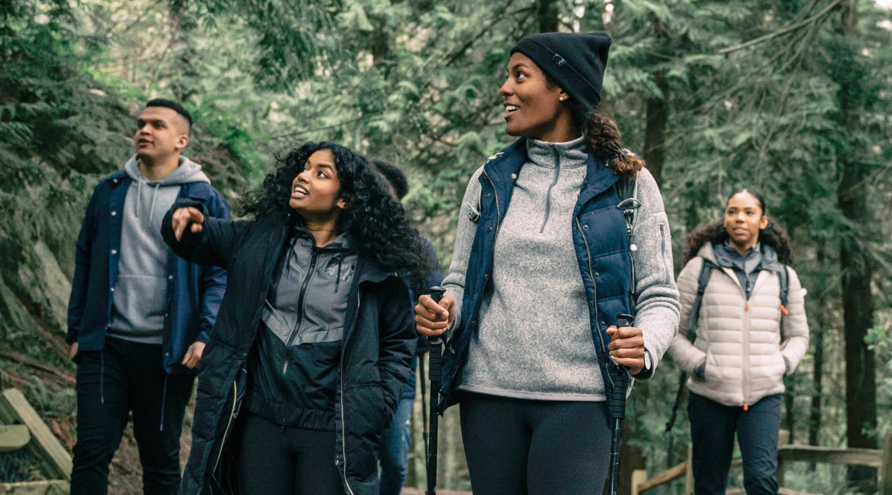 Life Is An Adventure Lifestyle photo woman lead a group of youths hiking through the woods